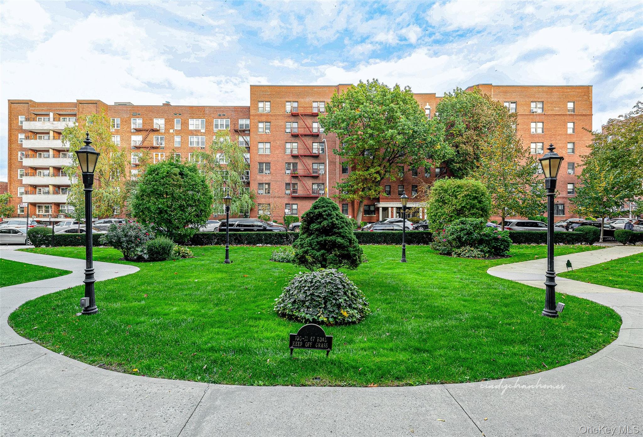 100-11 67th Road, Unit 508 Queens, NY 11375 - Photo 23 of 24 a view of a garden with a multi story residential apartment building
