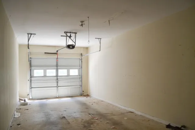 an empty room with windows and cabinet