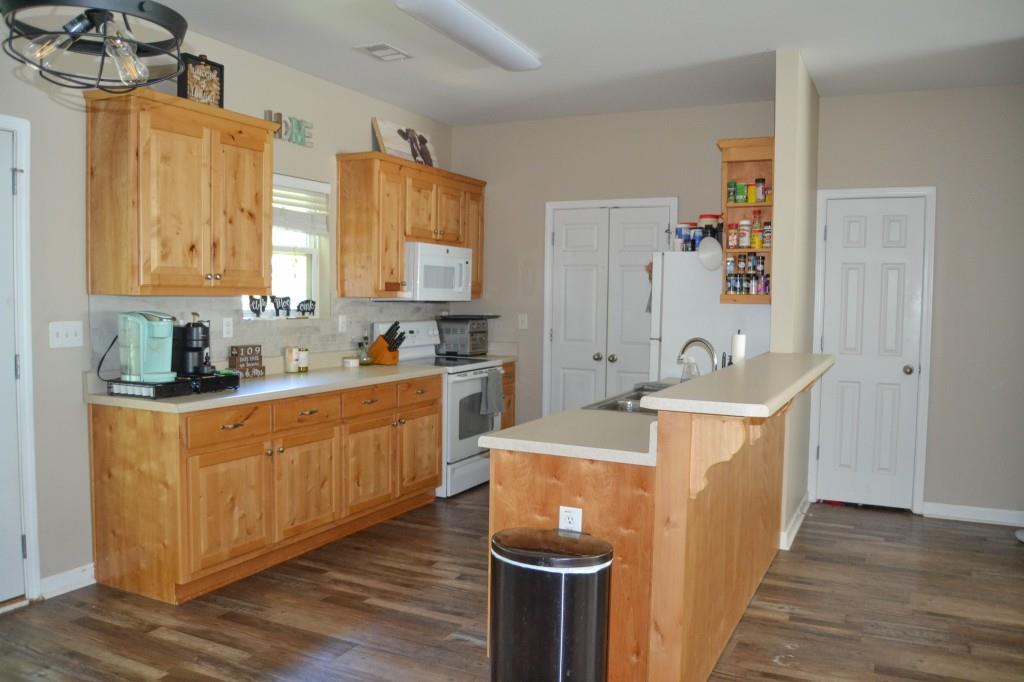 302 Pointe Circle Dahlonega, GA 30533 - Photo 3 of 19 a kitchen with stainless steel appliances granite countertop a sink a stove and a refrigerator