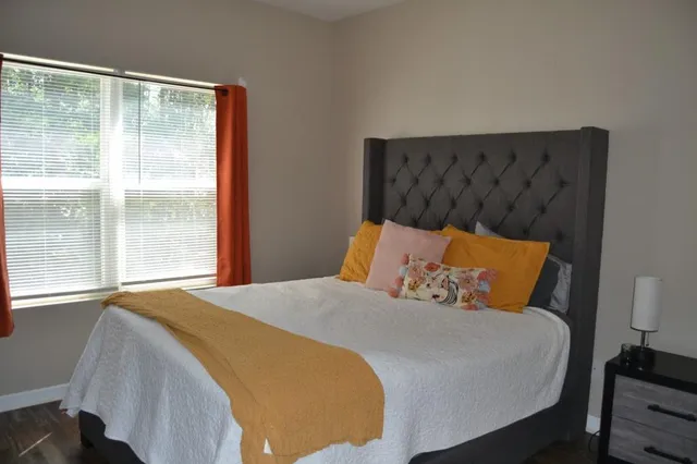 a bedroom with a bed and window