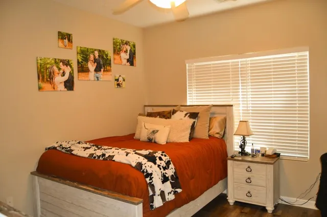 a bedroom with a bed and painting on the wall