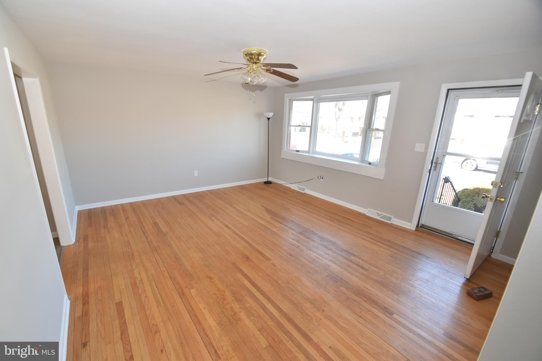 1105 Ralph Road Newark, DE 19713 - Photo 5 of 41 a view of an empty room with wooden floor and a window