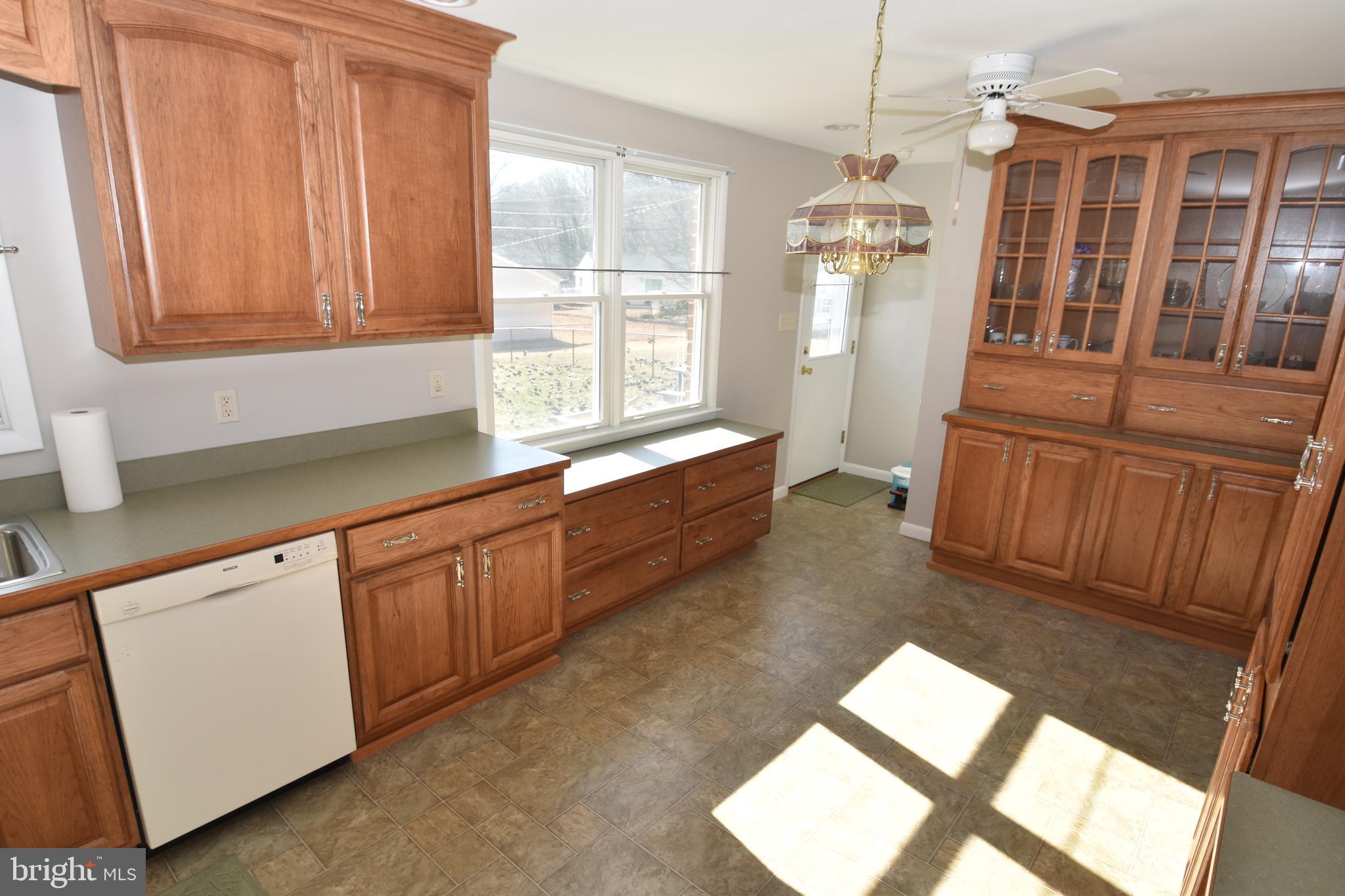 1105 Ralph Road Newark, DE 19713 - Photo 6 of 41 a kitchen with granite countertop a refrigerator and wooden cabinets