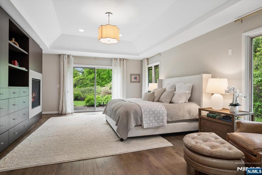 39 Eagle Nest Road Morris Township, NJ 07960 - Photo 23 of 43 a spacious bedroom with a bed and a flat screen television