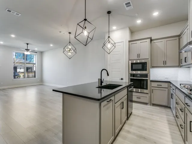 a view of a living room hardwood floor and a kitchen