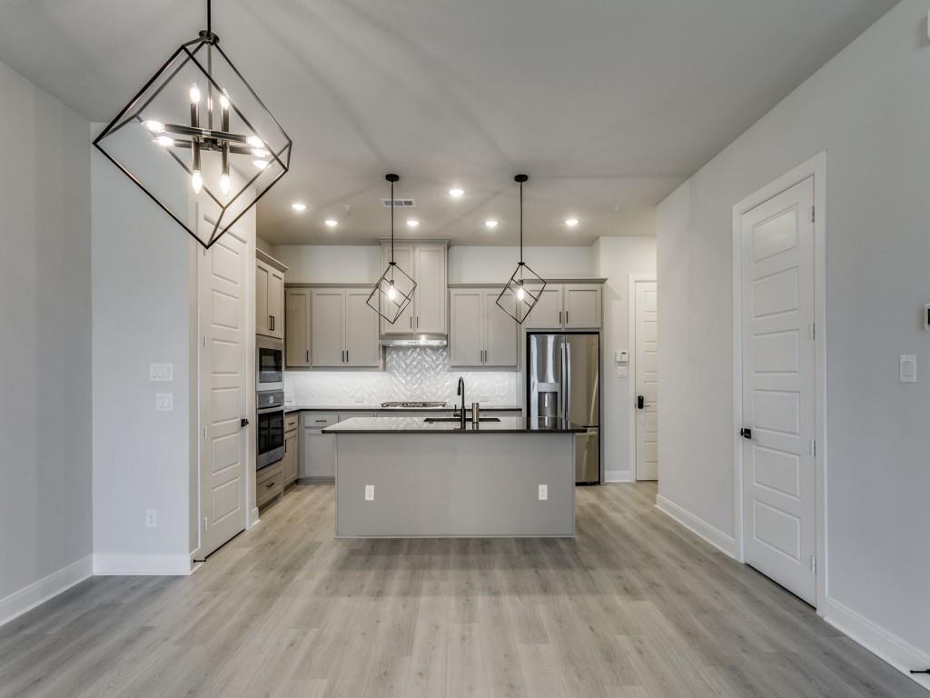 4823 Fuller Court, Unit 1003 Irving, TX 75038 - Photo 11 of 40 a kitchen with stainless steel appliances a refrigerator sink and stove