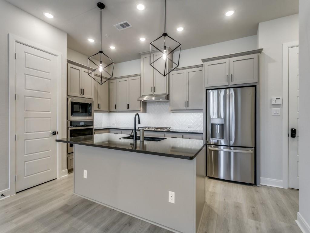 4823 Fuller Court, Unit 1003 Irving, TX 75038 - Photo 13 of 40 a kitchen with stainless steel appliances granite countertop a refrigerator a sink and a stove