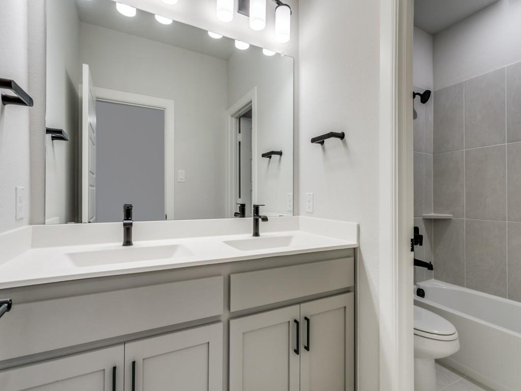 4823 Fuller Court, Unit 1003 Irving, TX 75038 - Photo 24 of 40 a bathroom with a sink a toilet and a mirror