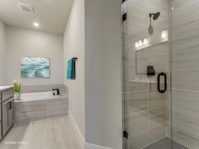 a bathroom with a bathtub and a shower