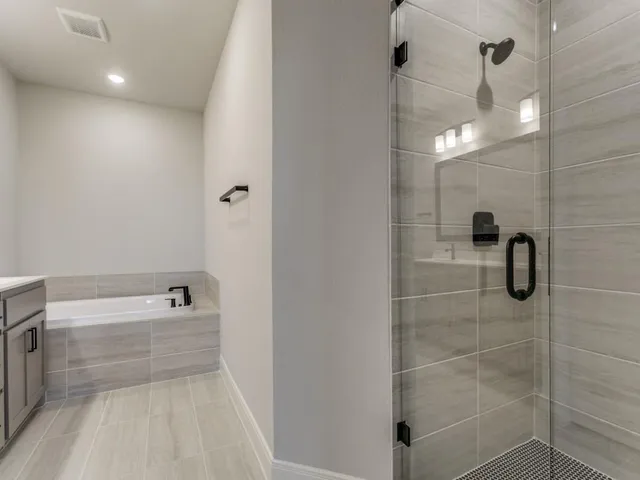 a bathroom with a shower and a bathtub