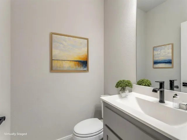 a bathroom with a sink a toilet and mirror