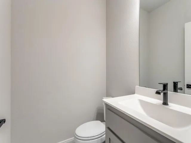 a white toilet sitting next to a bathroom sink