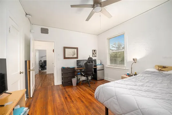 a view of a livingroom with workspace and a window