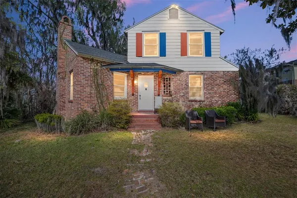 a front view of a house with a garden