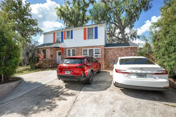 a kitchen with a sink cabinets stainless steel appliances and a window