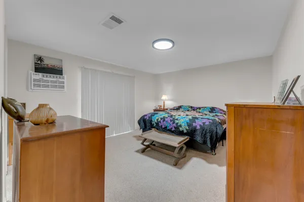 a bedroom with a bed and a desk