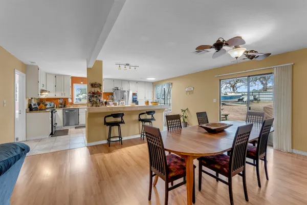 a view of a dining room with furniture and wooden floor
