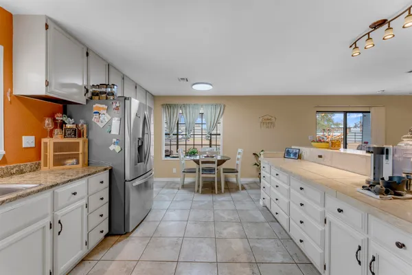 a kitchen with stainless steel appliances a sink cabinets and wooden floor