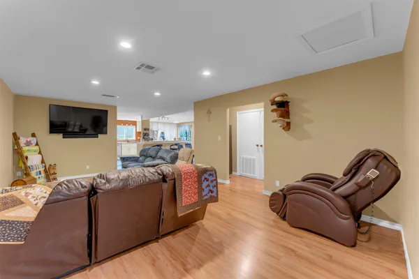 a living room with furniture and a wooden floor