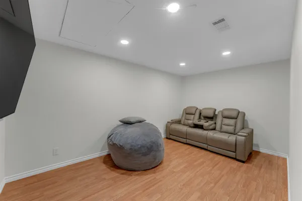 a room with a wooden floor and a rug