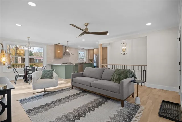 a living room with furniture and a view of kitchen