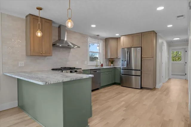 a kitchen with a sink a refrigerator and window