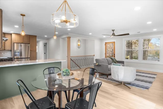 a view of a dining room with furniture wooden floor and chandelier