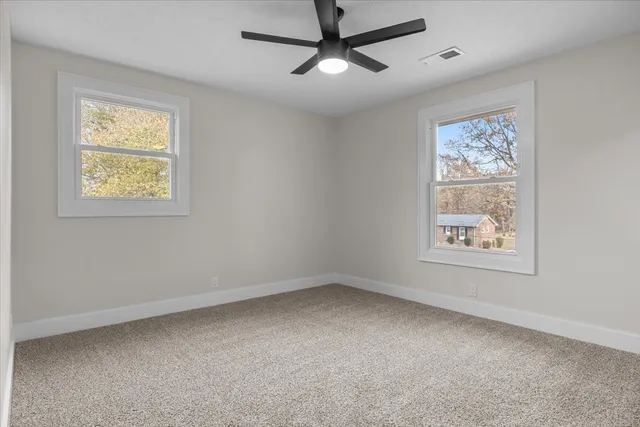 a view of room with window and ceiling fan