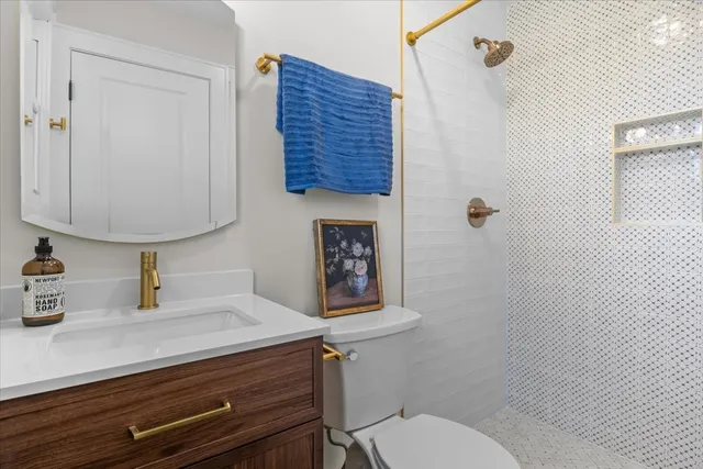 a bathroom with a toilet a sink and mirror