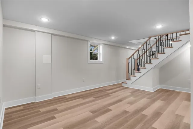 a view of entryway and hall with wooden floor