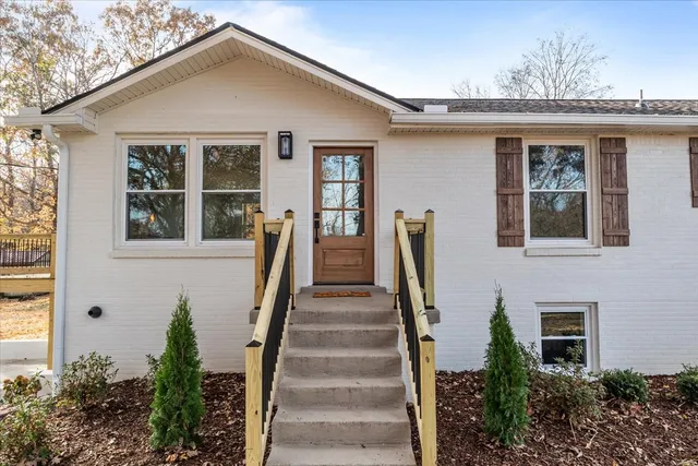 a view of a house with more windows and flower plants