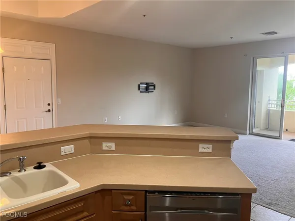 a kitchen with stainless steel appliances kitchen island granite countertop a refrigerator and a sink