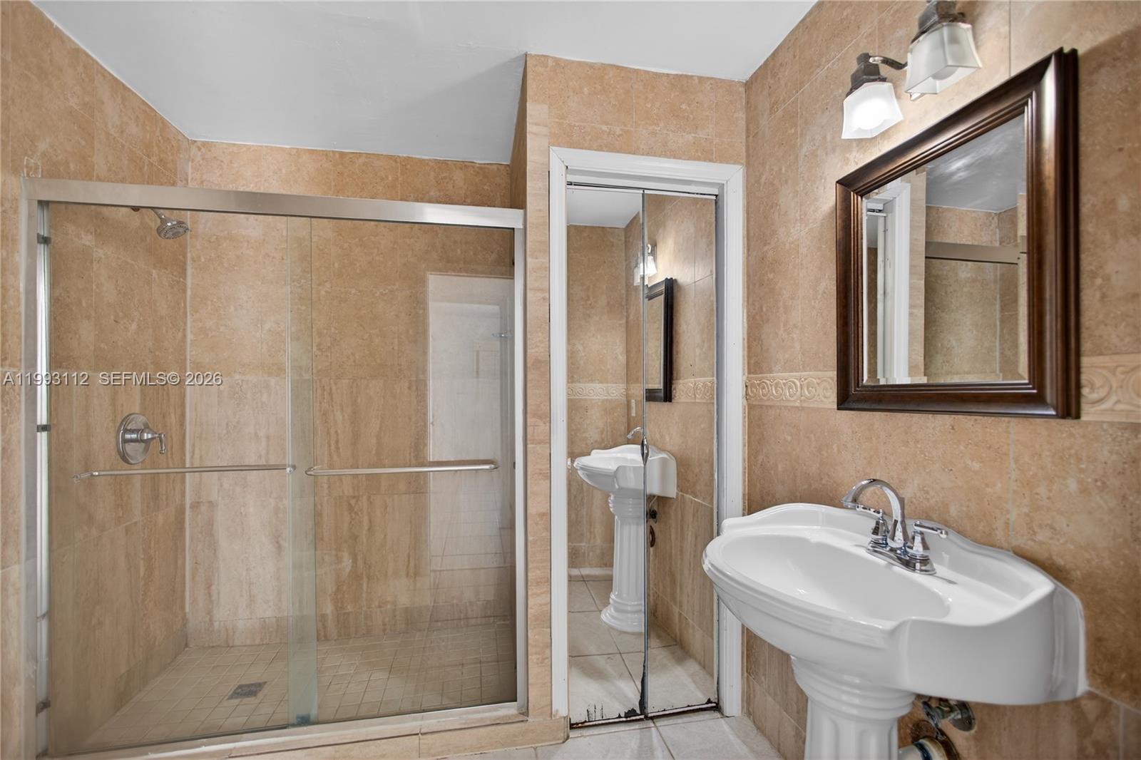 13471 Southwest 99th Terrace Miami, FL 33186 - Photo 26 of 44 a bathroom with a sink and a mirror