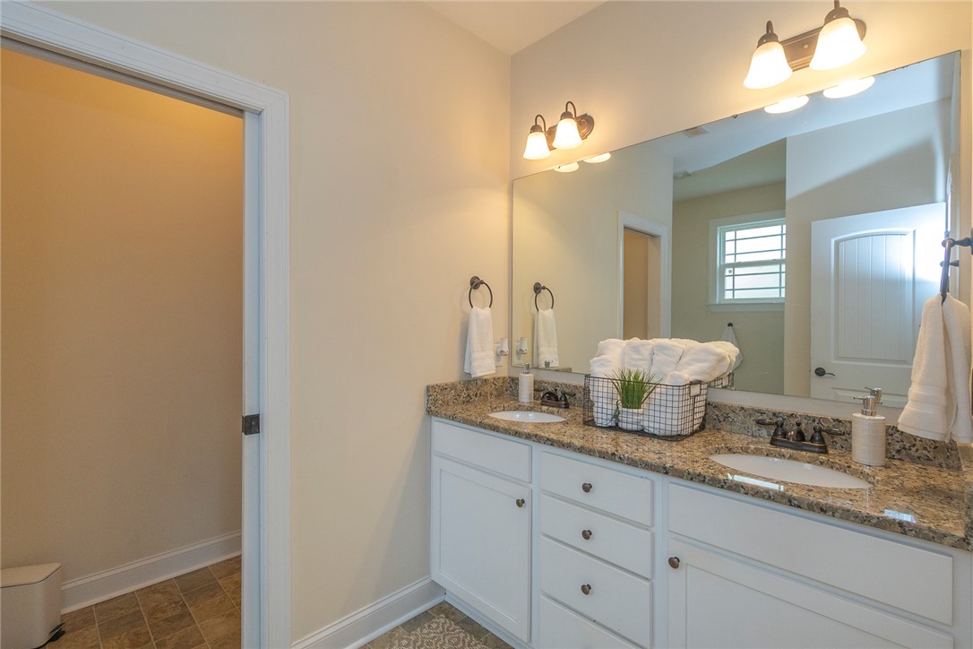 234 Streams Way Anderson, SC 29625 - Photo 31 of 44 This bathroom features a double vanity with granite counters, offering functional elegance.