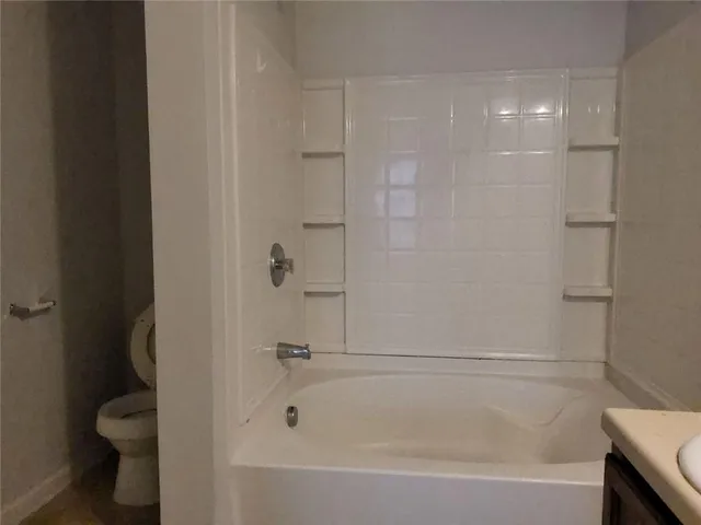 a bathroom with a bathtub and toilet