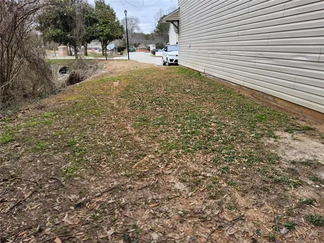 a view of a yard with a tree