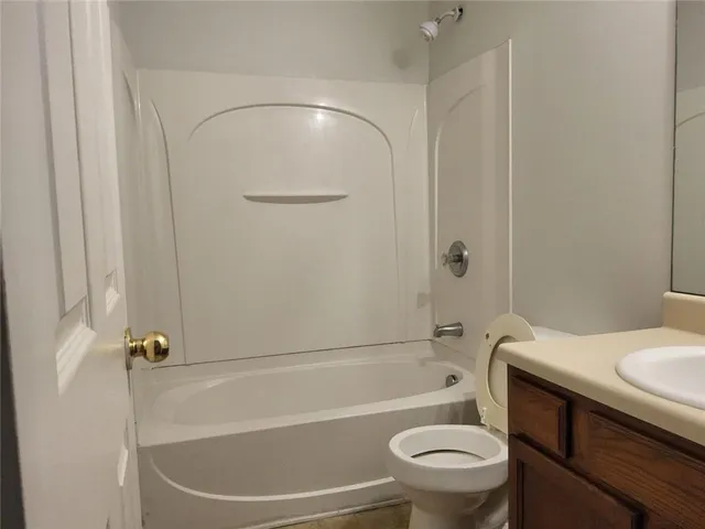 a bathroom with a sink a toilet and a bathtub
