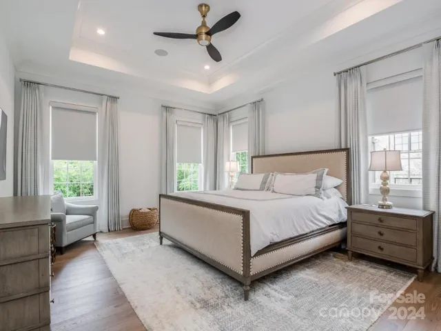 a spacious bedroom with a bed and a couch