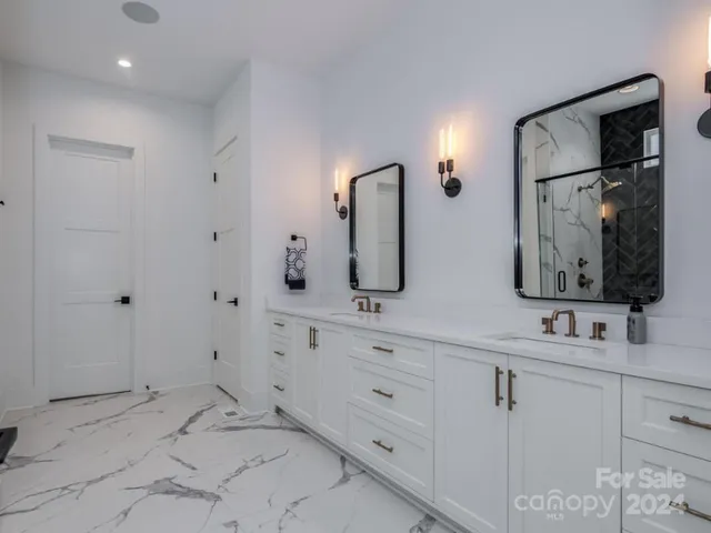 a bathroom with double vanity sink and a mirror