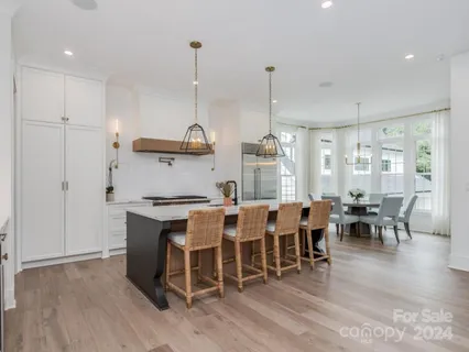 a large kitchen with a table and chairs
