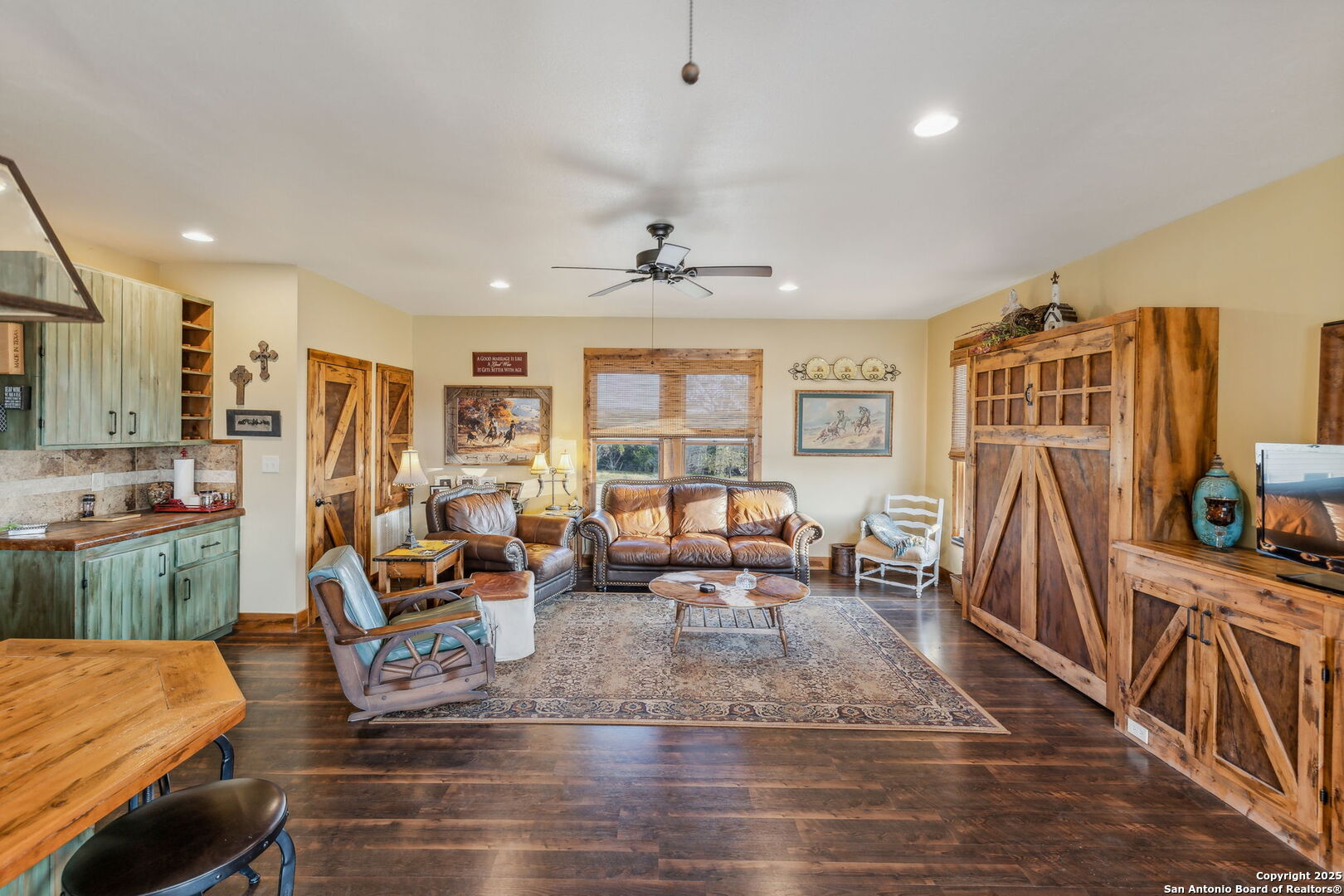 232 Stoneleigh Road Center Point, TX 78010 - Photo 14 of 34 a living room with furniture a wooden floor and a large window