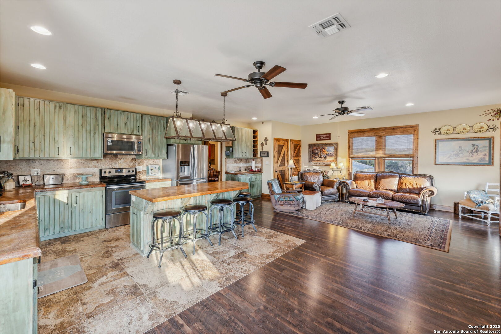 232 Stoneleigh Road Center Point, TX 78010 - Photo 9 of 34 a living room with furniture kitchen view and a wooden floor