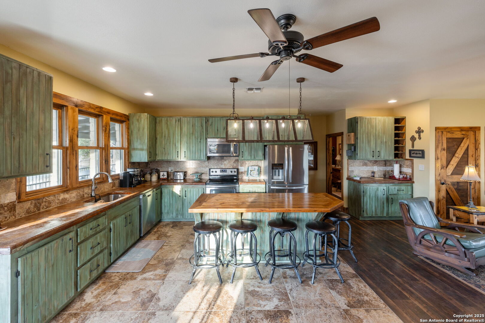 232 Stoneleigh Road Center Point, TX 78010 - Photo 10 of 34 a large kitchen with lots of counter space dining table and chairs