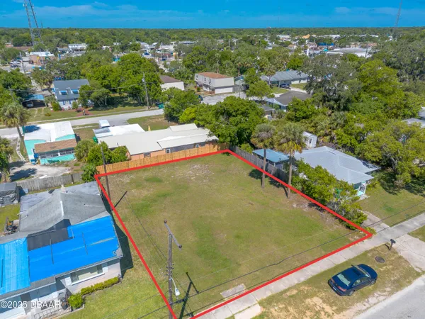 a view of a pool with a table and chairs