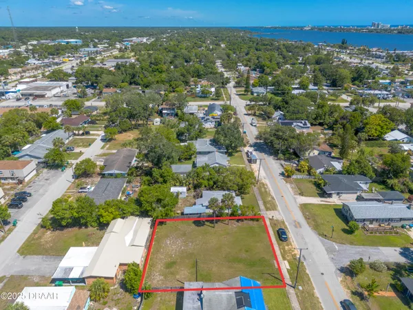 an aerial view of residential houses with outdoor space and street view