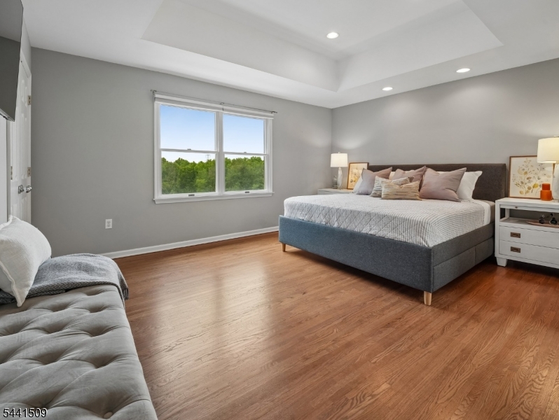 610 River Road Chatham, NJ 07928 - Photo 15 of 42 a spacious bedroom with a bed and window