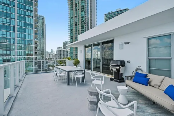 a view of a patio with couches chairs dining table and chairs