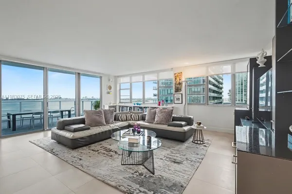 a living room with furniture and a large window