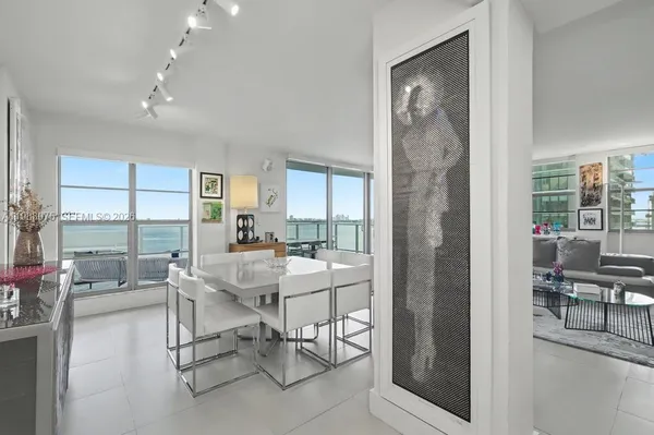 a work room with furniture and a large window