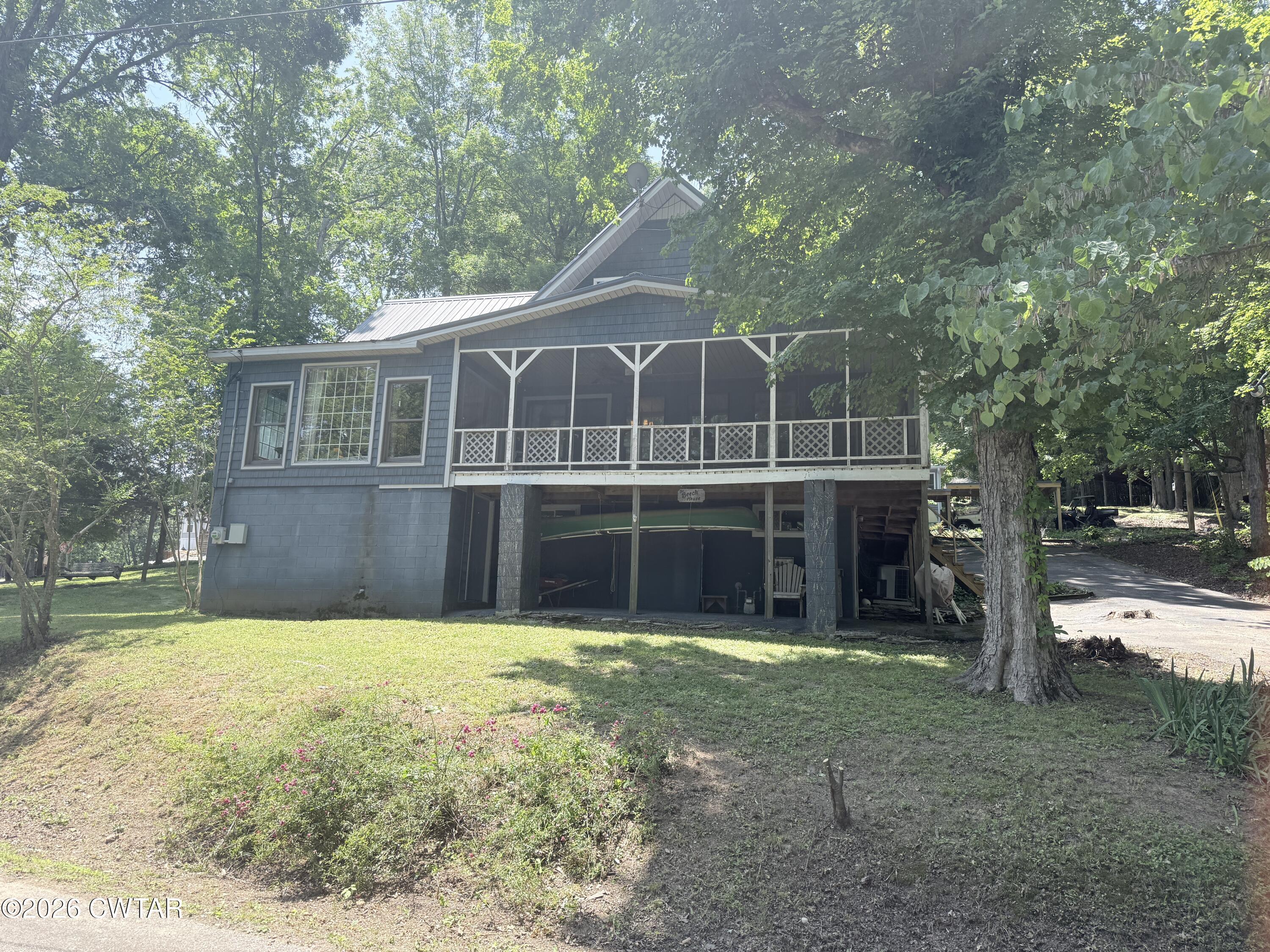 1060 Lost Creek Boat Dock Road Decaturville, TN 38329 - Photo 1 of 40 a view of a house with a yard and large trees